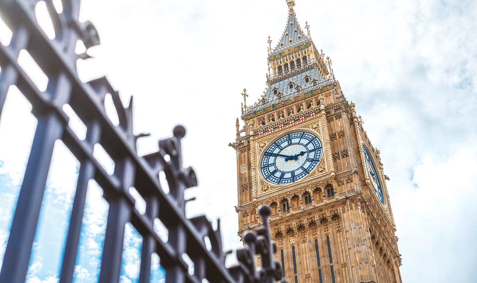 A large clock tower with a gold top. Description generated by AI