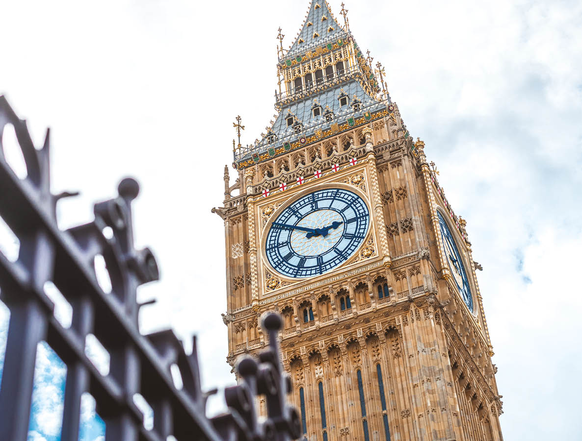 A large clock tower with a gold top. Description generated by AI