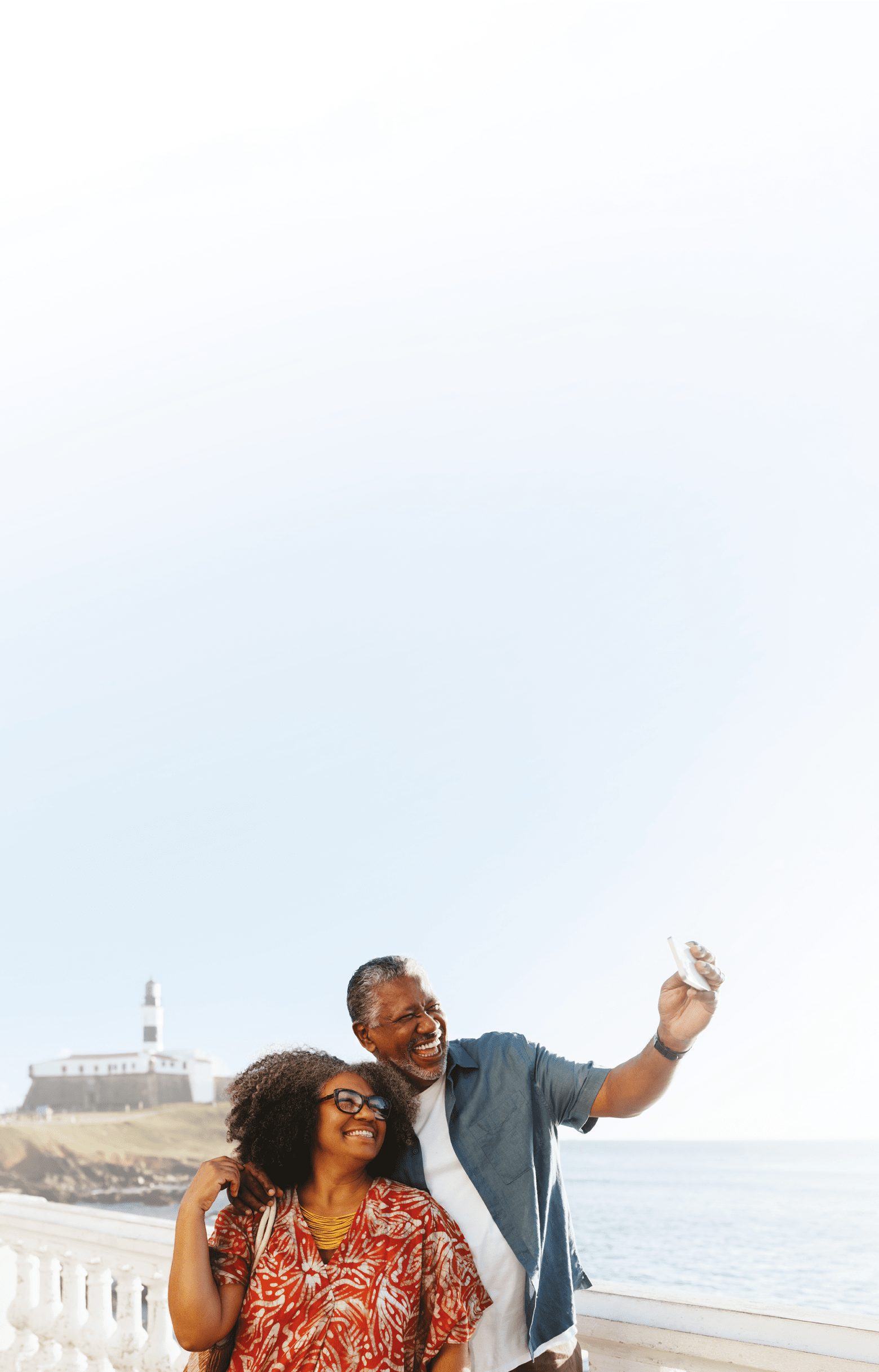 A man and woman standing on a pier taking a selfie. Description generated by AI