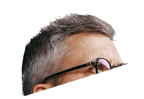 Man is enjoying cup of warm tea, coffee, having relaxing moment at home, standing on patio and looking at autumn nature around