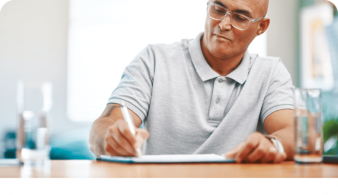 Home, documents and man writing, planning and life insurance with mortgage, update will and testament. Apartment, person or guy with paperwork, budget and retirement fund with schedule or information