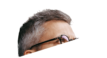 Man is enjoying cup of warm tea, coffee, having relaxing moment at home, standing on patio and looking at autumn nature around