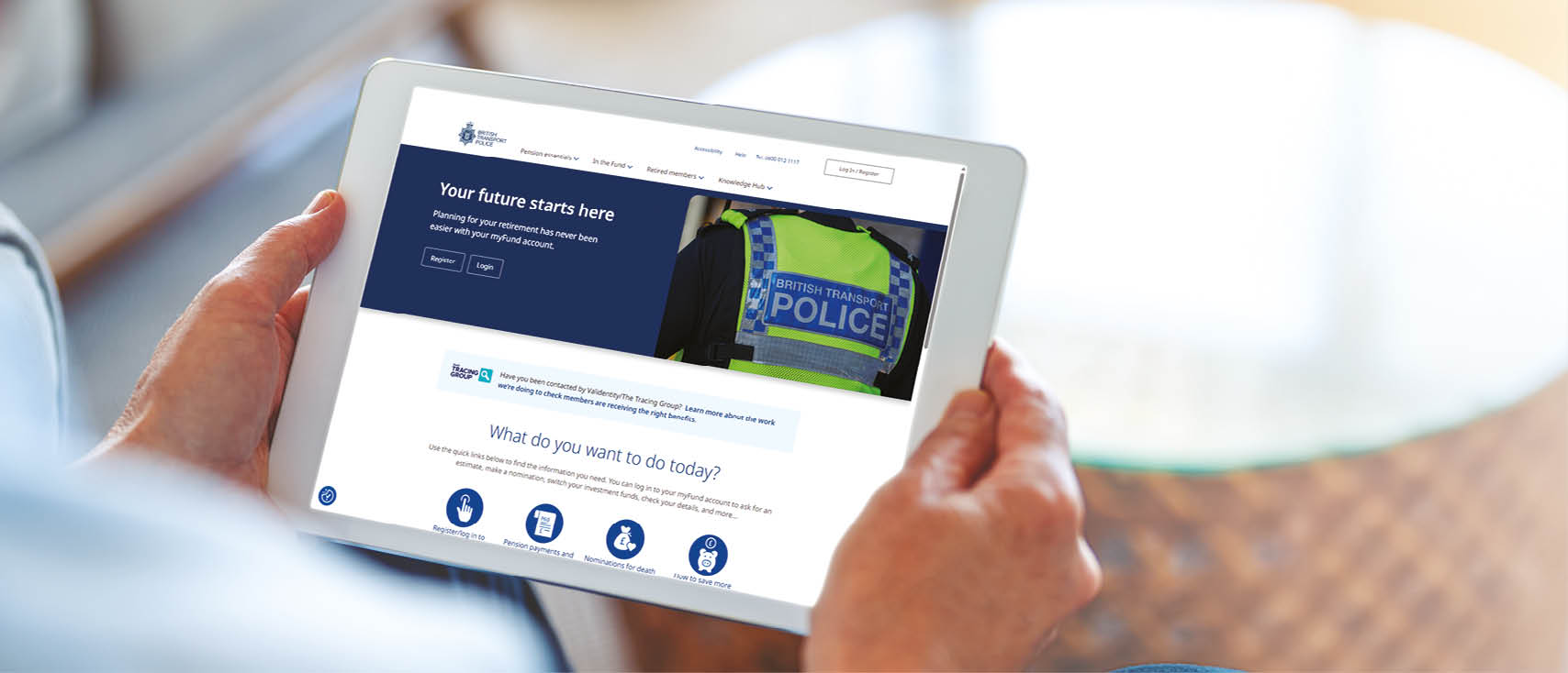 Mature man using a blank screen digital tablet at home. He is sitting on the sofa