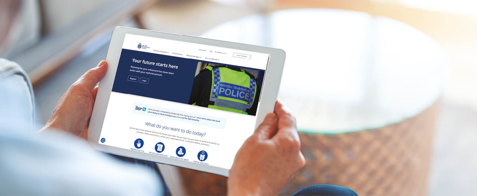 Mature man using a blank screen digital tablet at home. He is sitting on the sofa