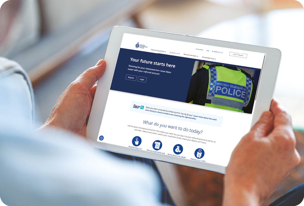 Mature man using a blank screen digital tablet at home. He is sitting on the sofa