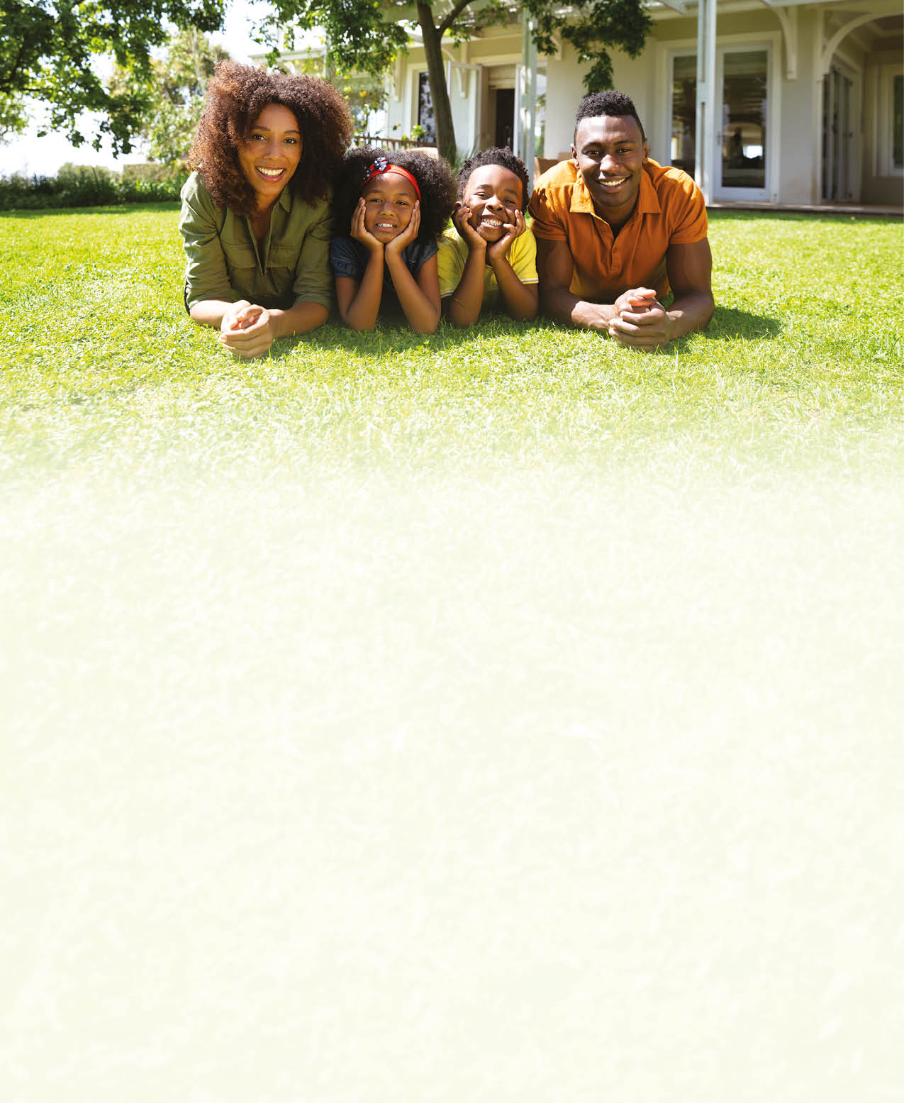 A family of four sitting on the grass. Description generated by AI