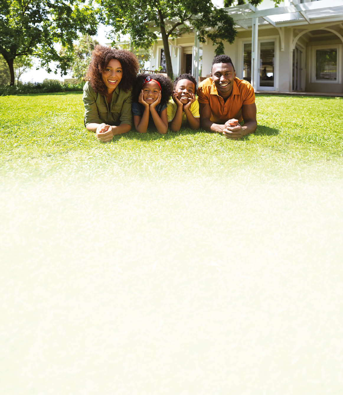 A family of four sitting on the grass. Description generated by AI