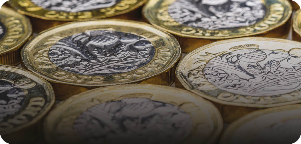 A stack of gold and silver coins. Description generated by AI