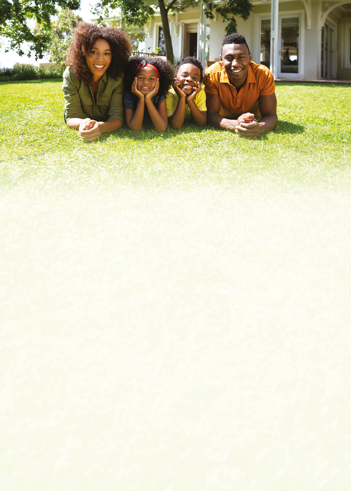 A family of four sitting on the grass. Description generated by AI