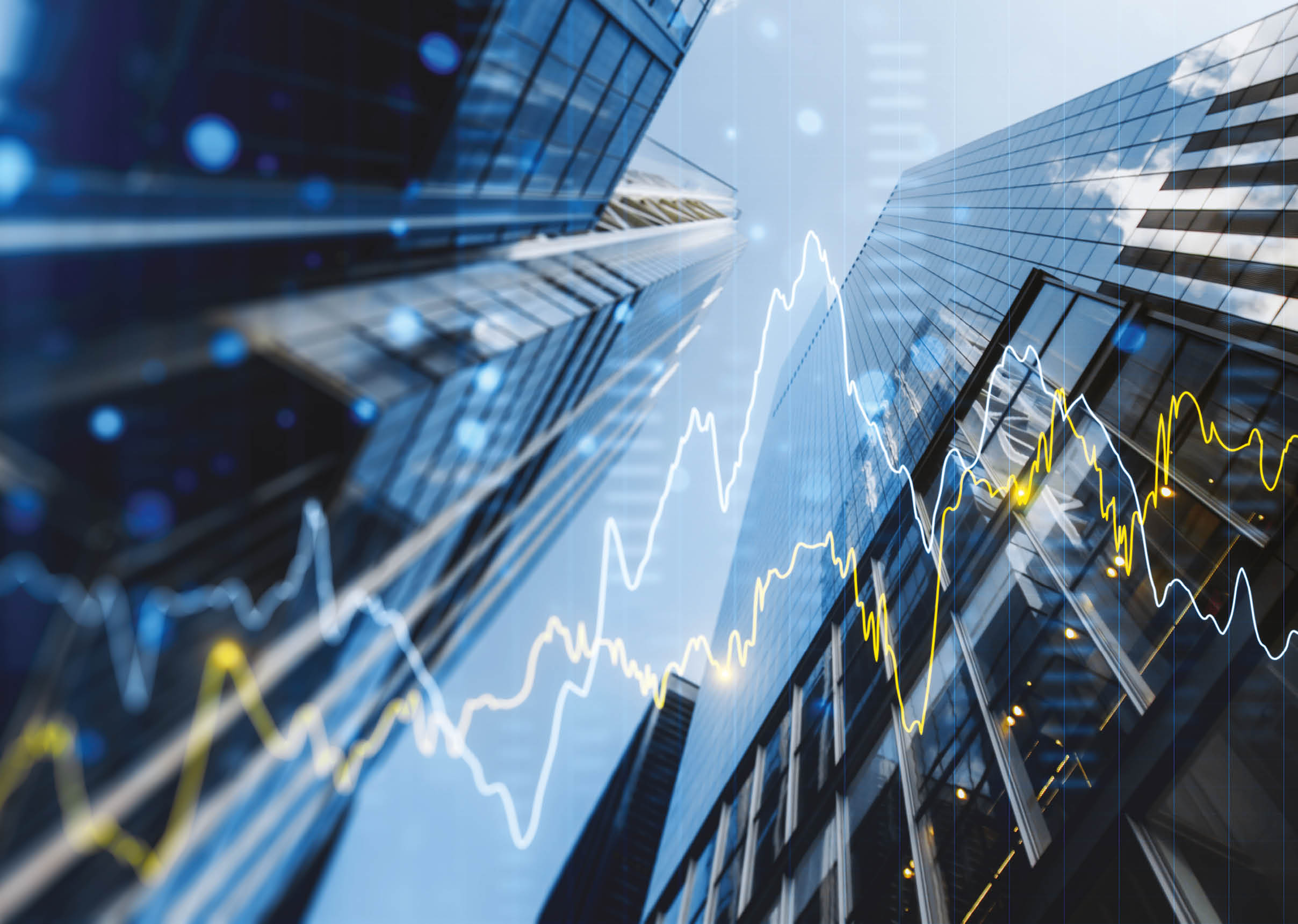 A double exposure image of skyscrapers with overlay of financial graphs, set against a blurred background, illustrating the concept of business growth