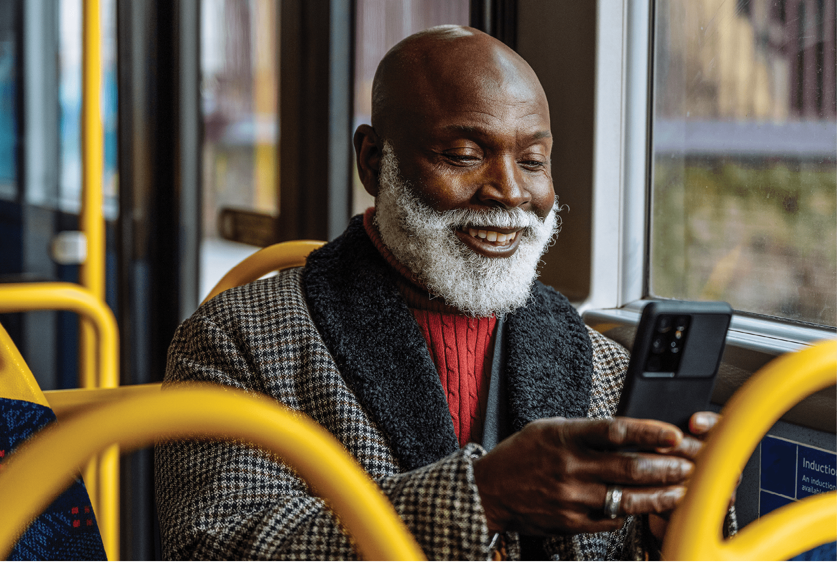 Senior African - Afro-Caribbean smart dressed man in the city, using public transportation. Image taken in London, UK