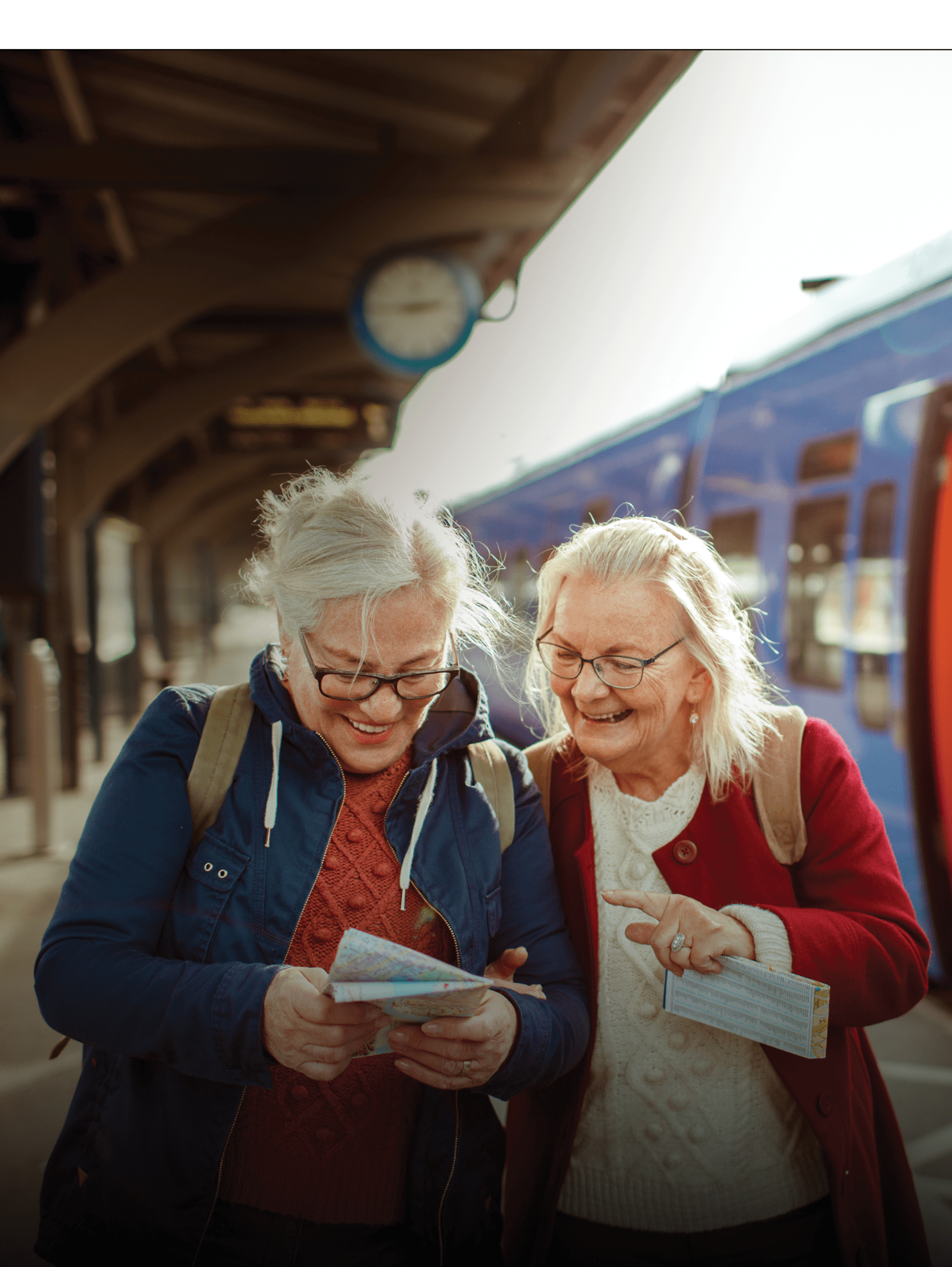 Close up of two seniors at a train station