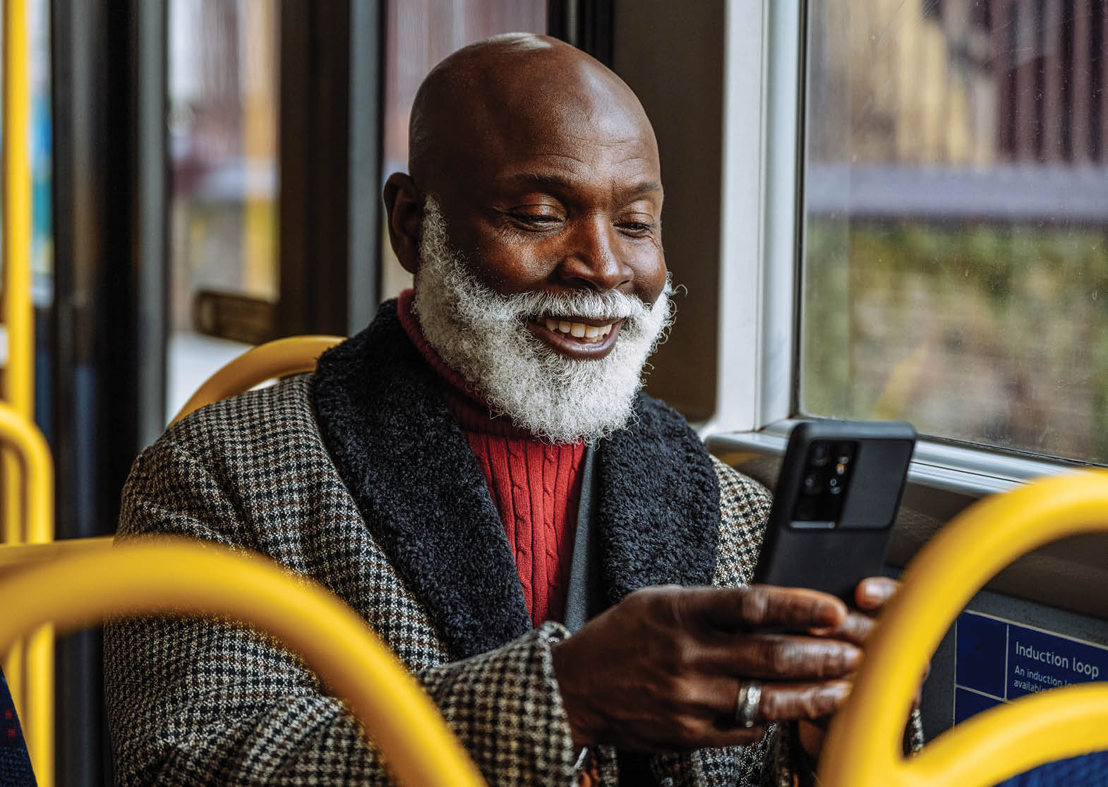 Senior African - Afro-Caribbean smart dressed man in the city, using public transportation. Image taken in London, UK