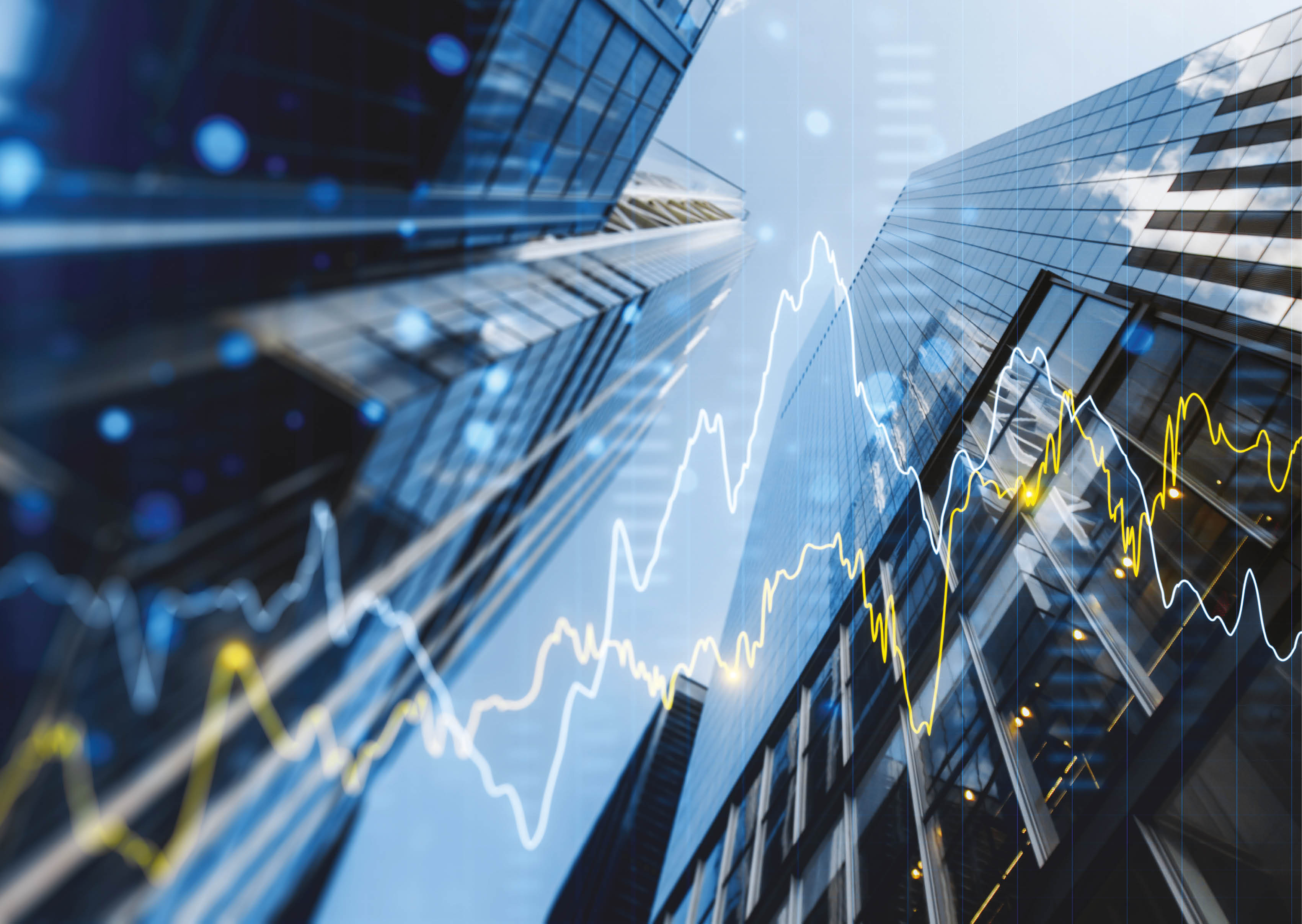 A double exposure image of skyscrapers with overlay of financial graphs, set against a blurred background, illustrating the concept of business growth