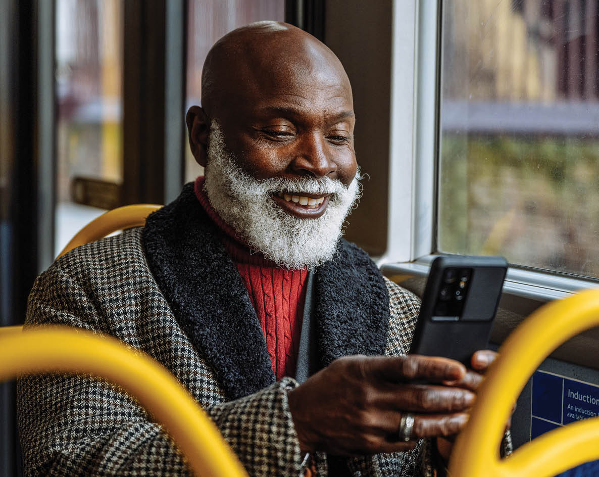 Senior African - Afro-Caribbean smart dressed man in the city, using public transportation. Image taken in London, UK