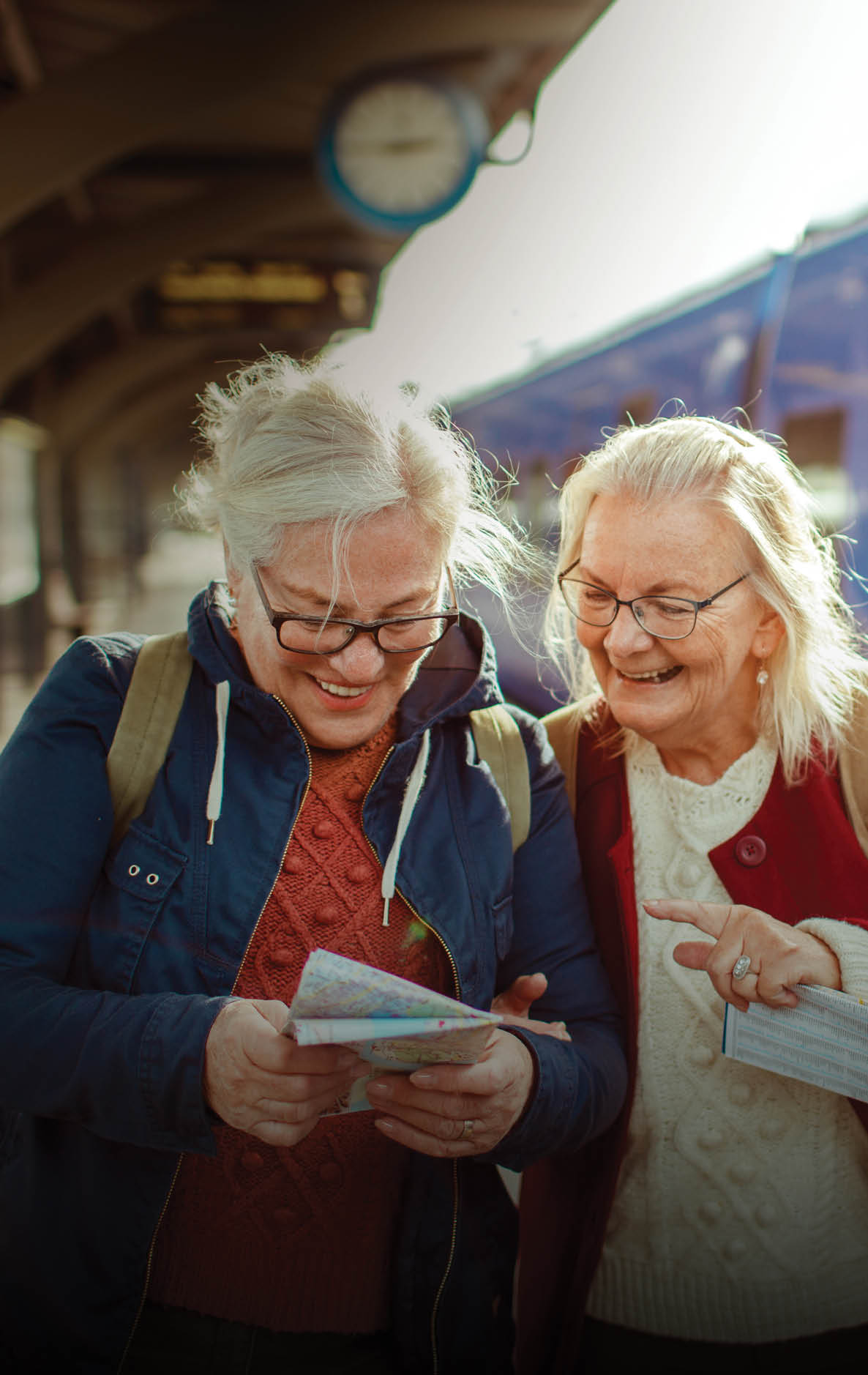 Close up of two seniors at a train station
