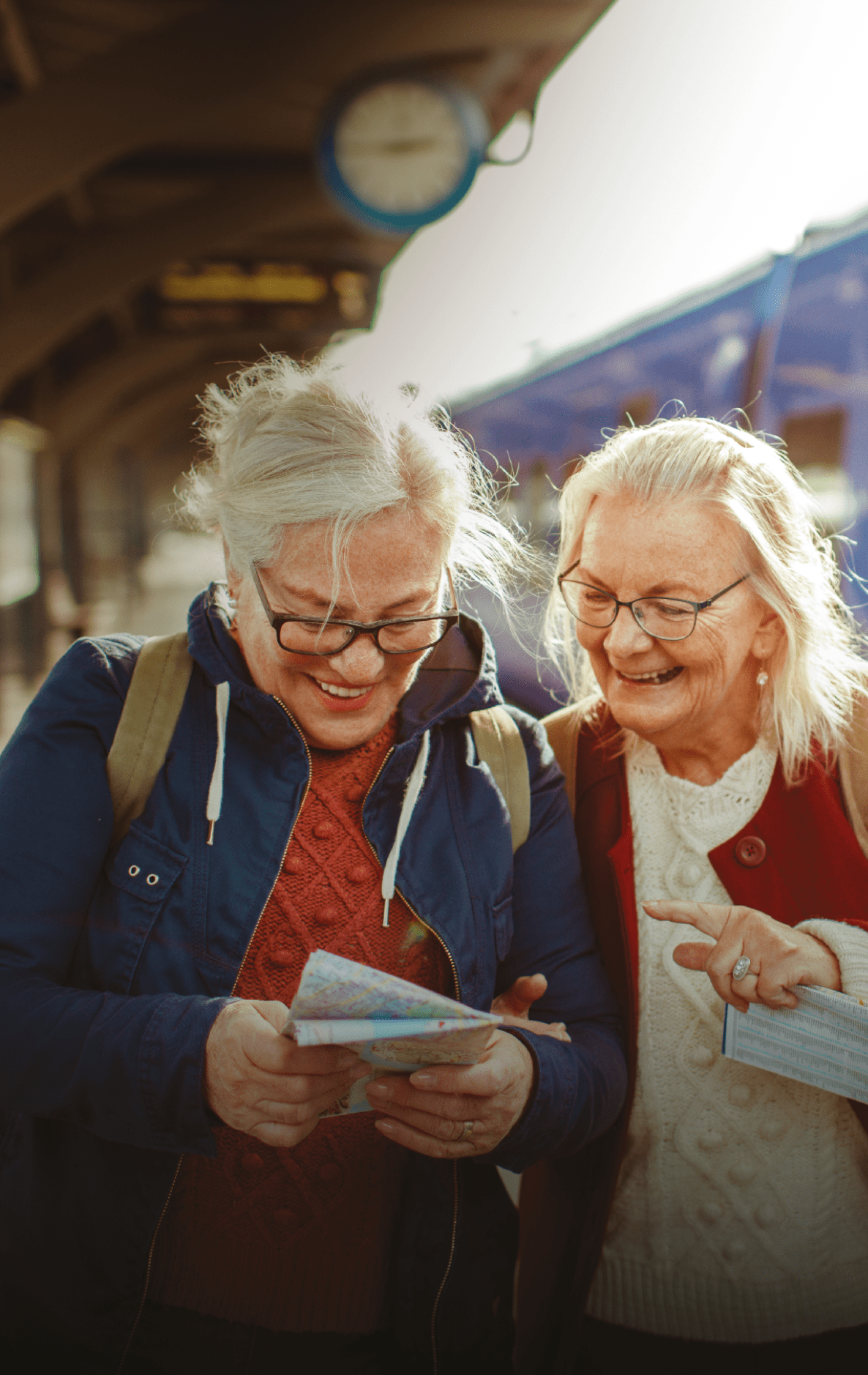Two women are standing next to a train, looking at a map. AI generated content