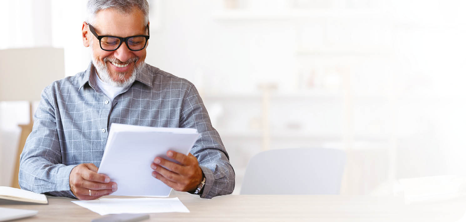 A man is sitting at a desk, reading a book. AI generated content