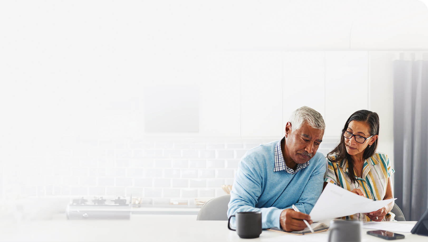 A man and woman are sitting at a table, looking at a cell phone. AI generated content