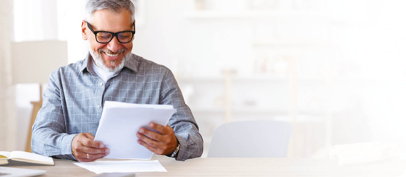 A man is sitting at a desk, reading a book. AI generated content