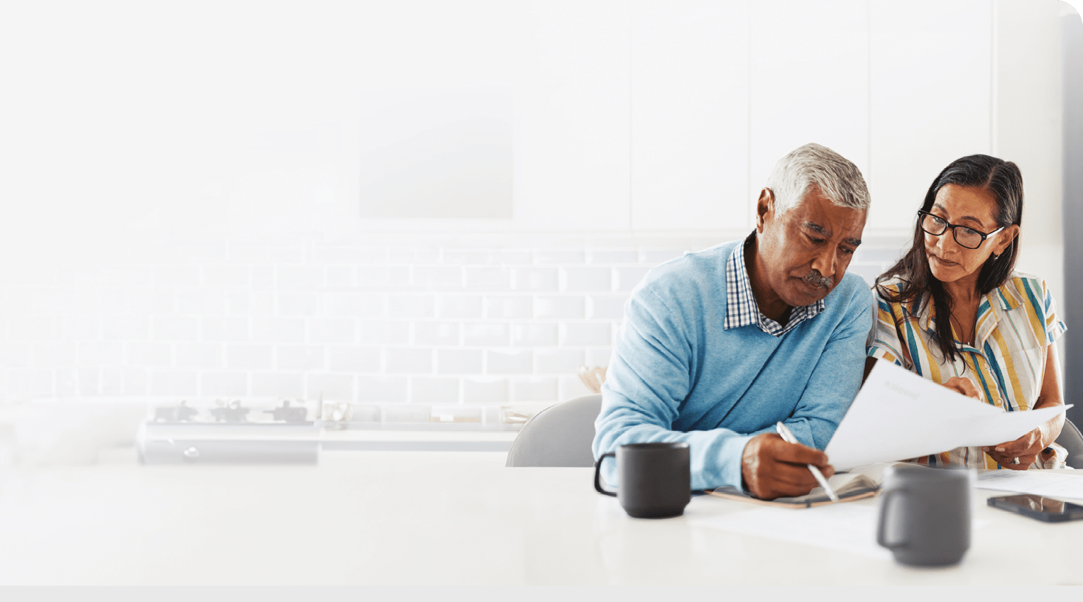 A man and woman are sitting at a table, looking at a cell phone. AI generated content