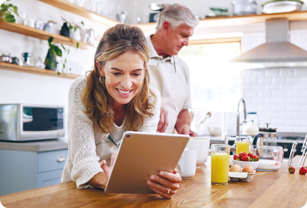 Woman, tablet and old couple in home kitchen on social media, internet surfing or reading news. Retirement, elderly husband and wife in house with 5g mobile and streaming web content on digital tech.