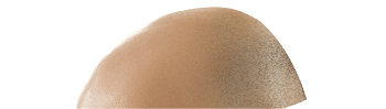 A man sitting on a couch holding a pink piggy bank. Description generated by AI