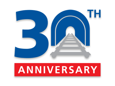 The number 30, with train tracks running through the zero, and the word anniversary written underneath