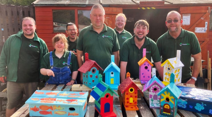 A group of people from The Phoenix Trust displaying bird boxes