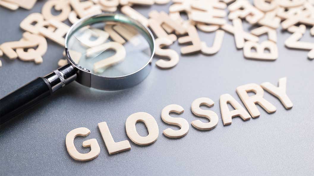 The word 'glossary' formed using cut out letters