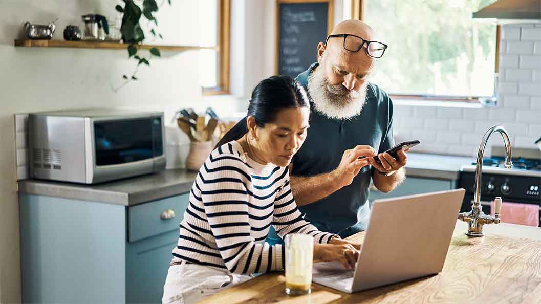 A man and a woman looking at laptop