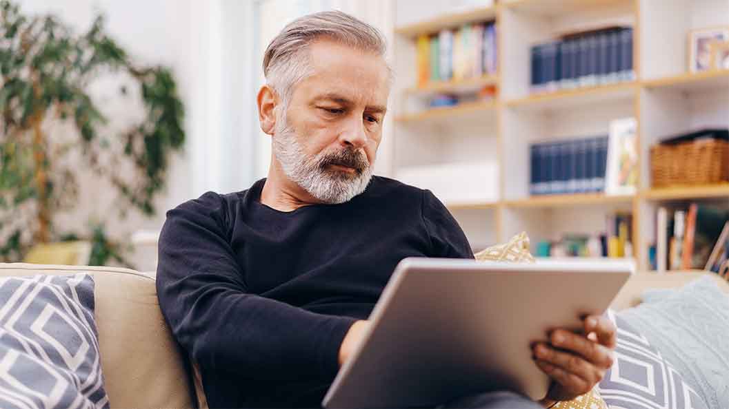 A man looking at a tablet