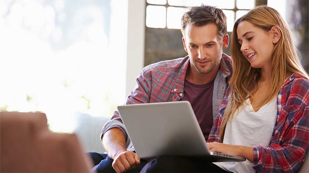 A young couple looking at laptop
