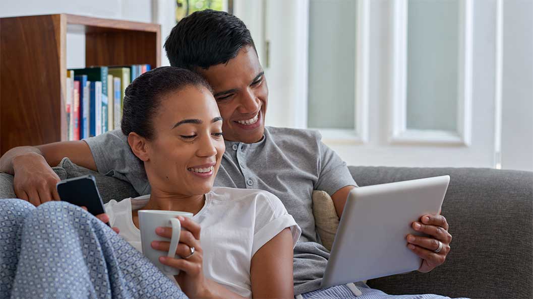 A young couple looking at laptop